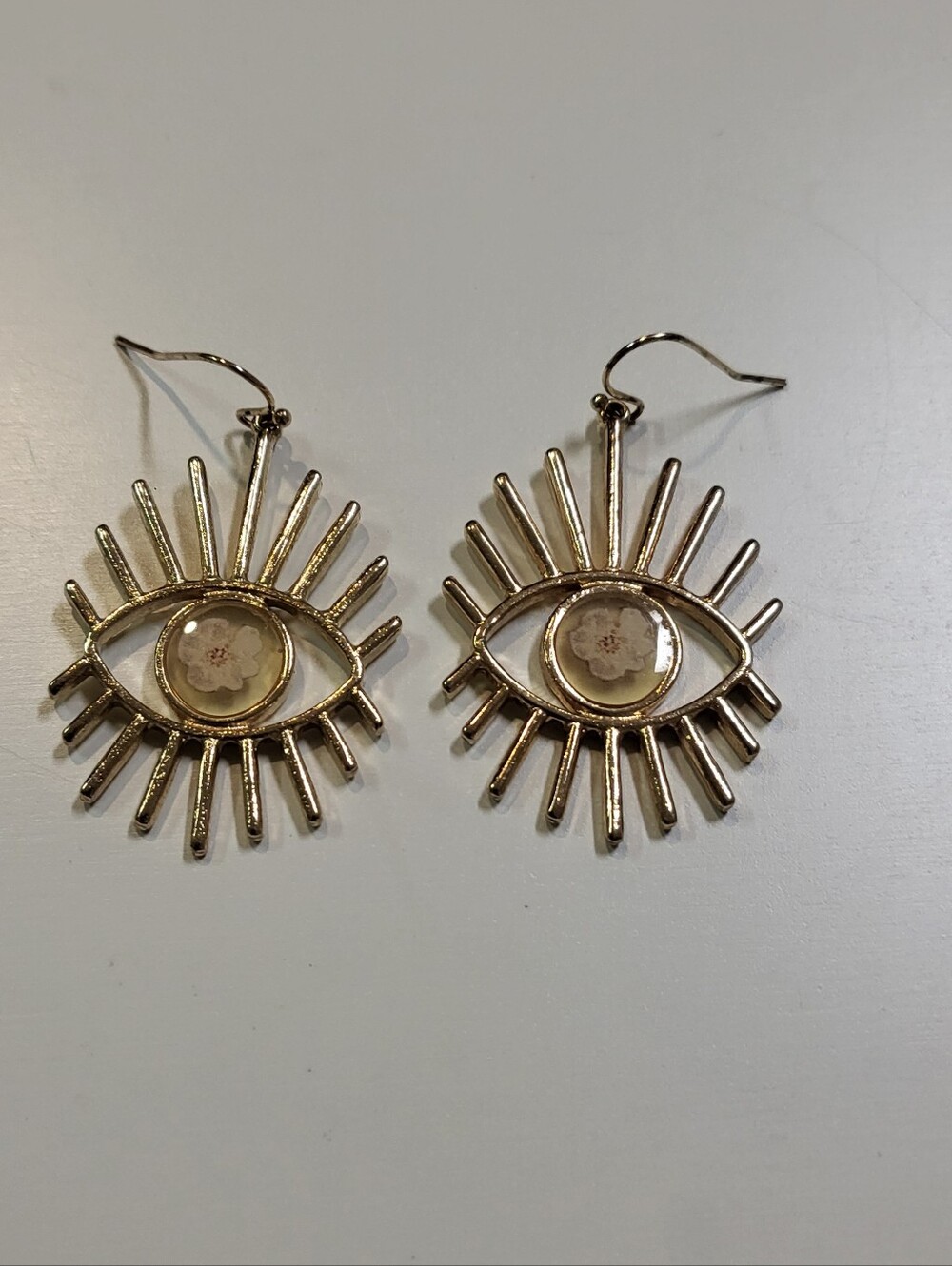 Gold Tone Evil Eye Drop Earrings with Pressed Floral Details